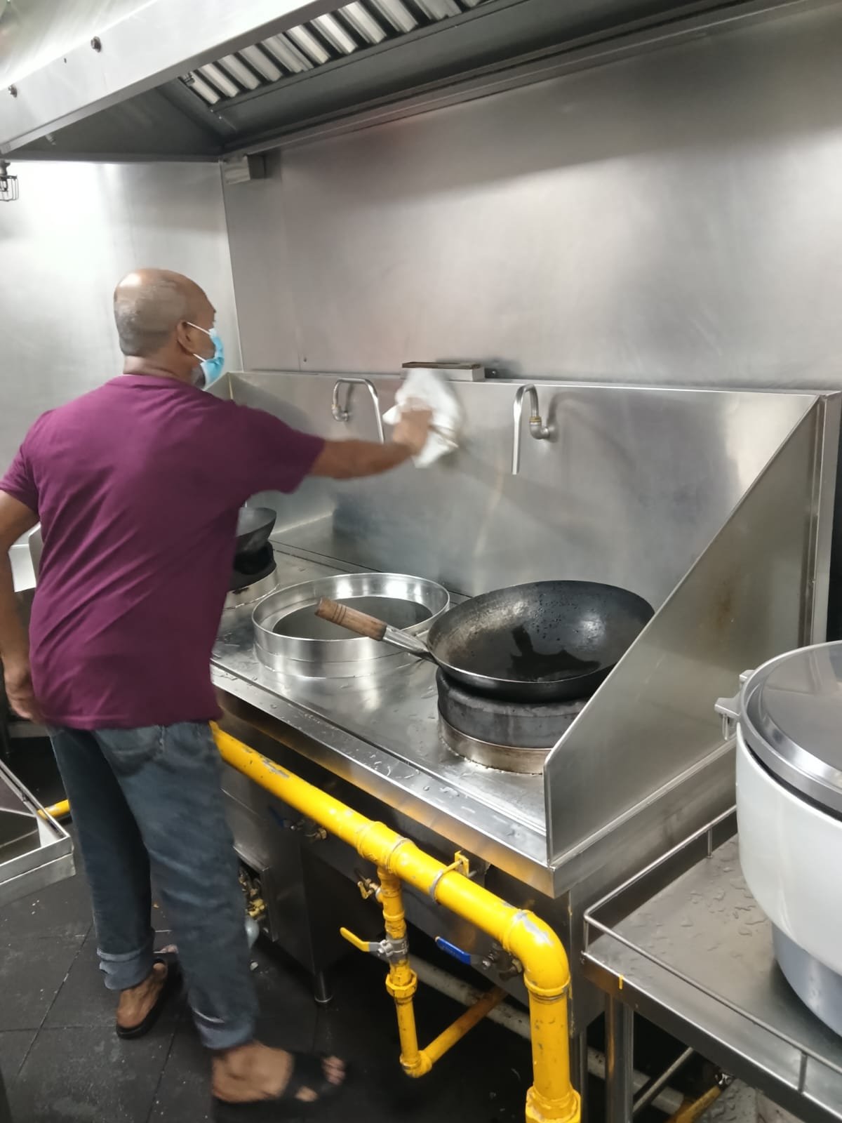 Sani Clean crew member mopping a back-of-house corridor
