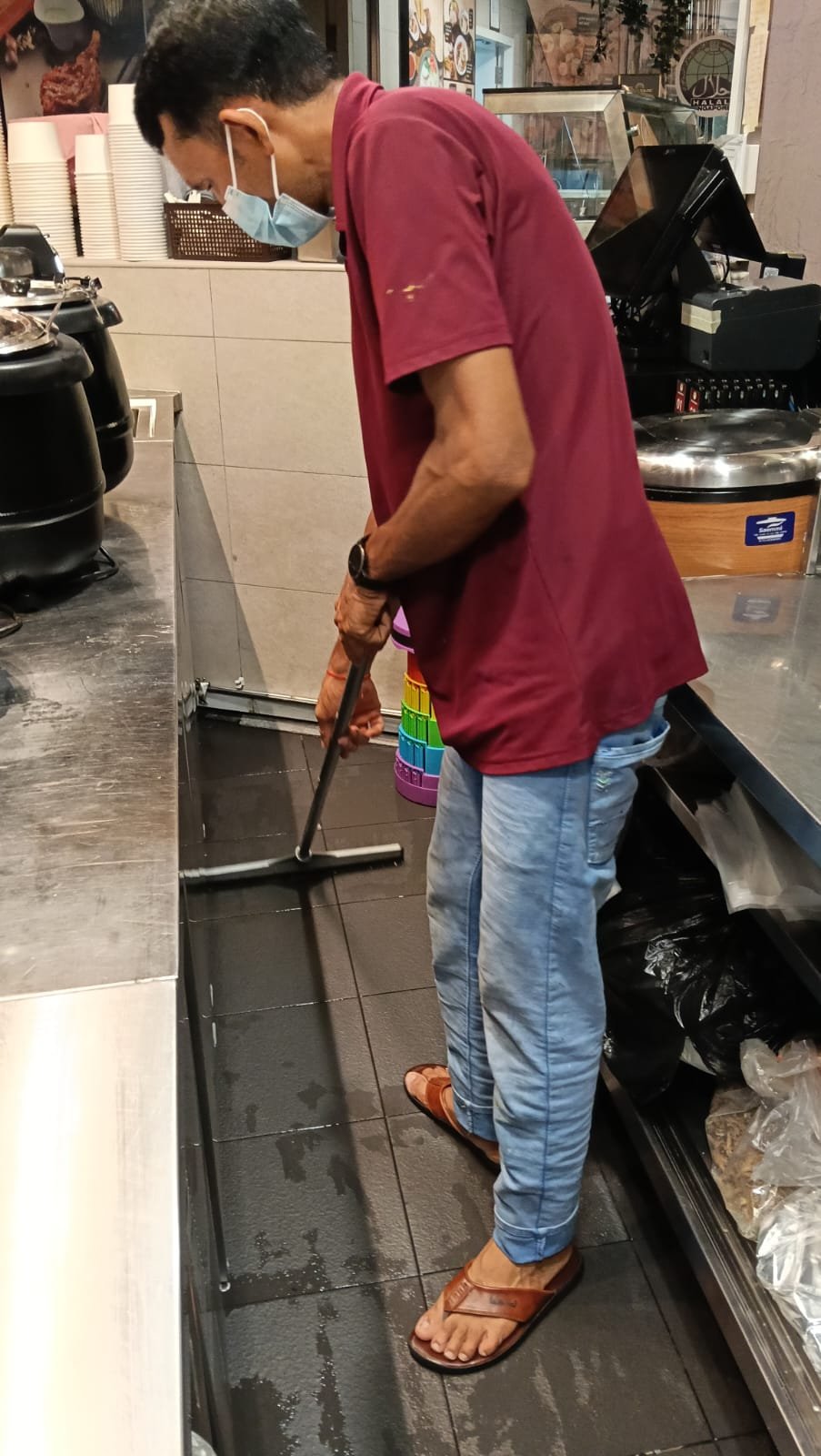 Sani Clean staff wiping a food preparation counter