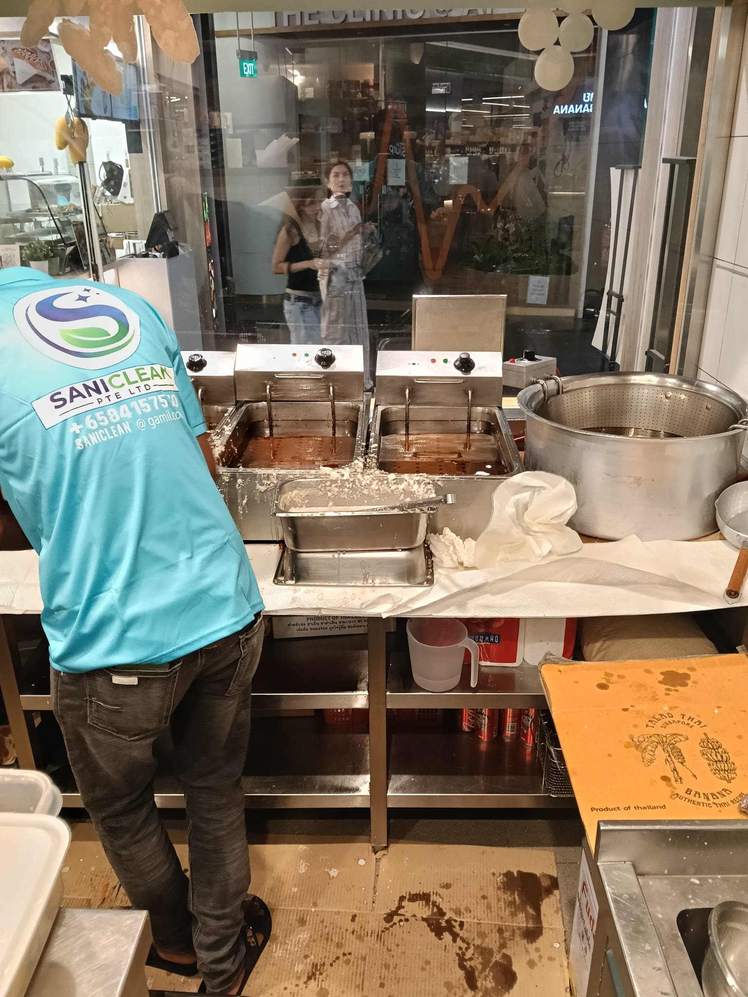 Sani Clean crew working near commercial fryers
