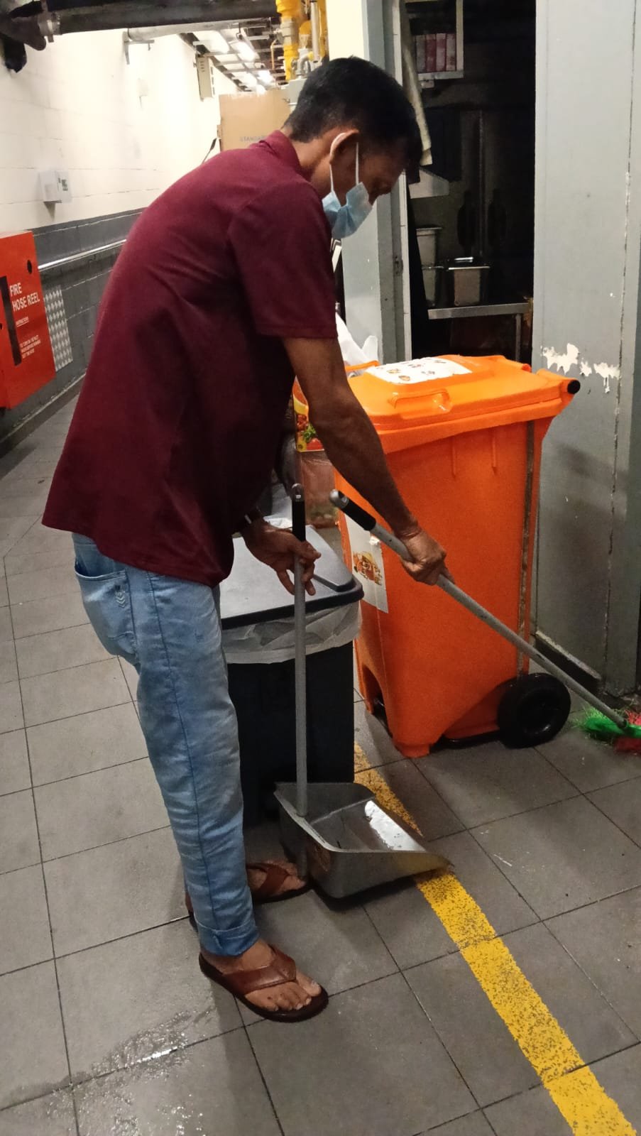 Sani Clean crew member cleaning a griddle plate