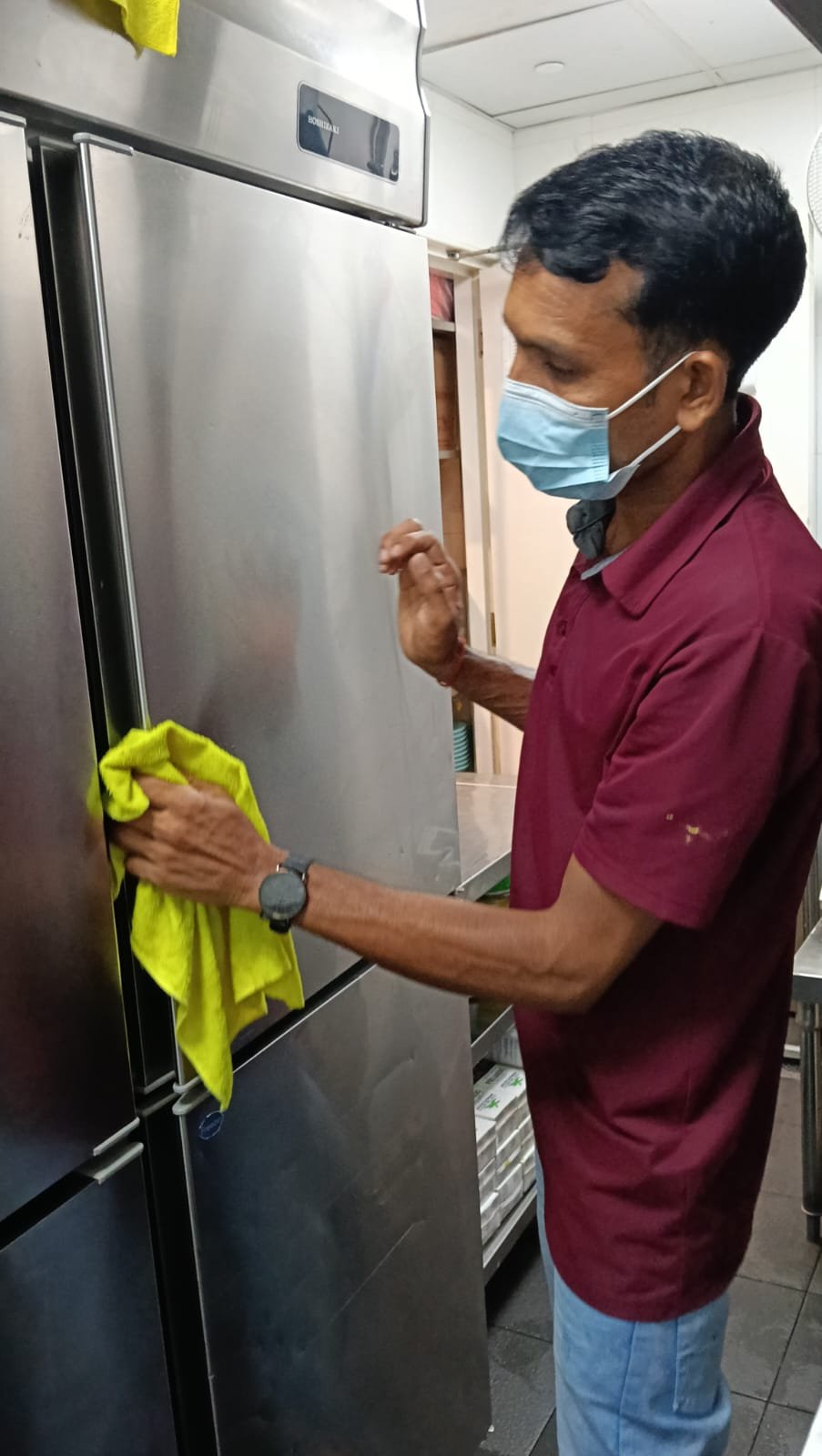 Sani Clean staff cleaning kitchen shelving