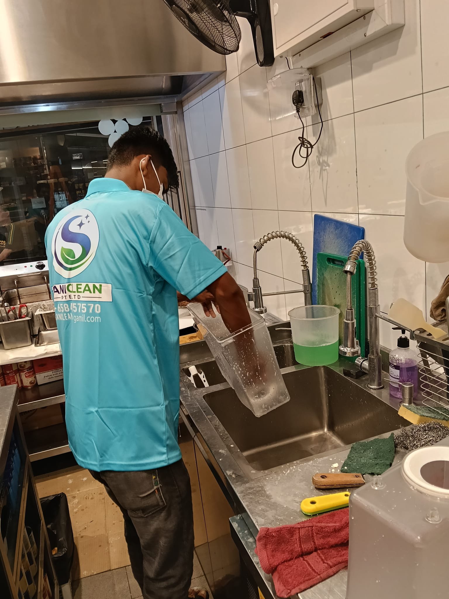 Sani Clean staff washing kitchen equipment